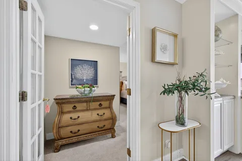 a bedroom with a bed and a flat tv screen on dresser
