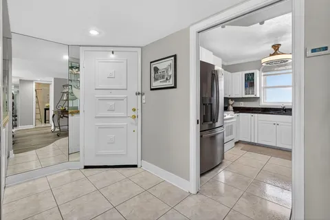 a kitchen with granite countertop a refrigerator and a sink