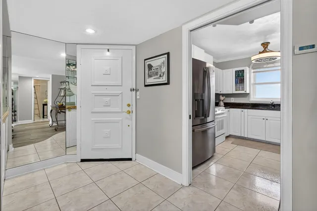 a kitchen with granite countertop a refrigerator and a sink