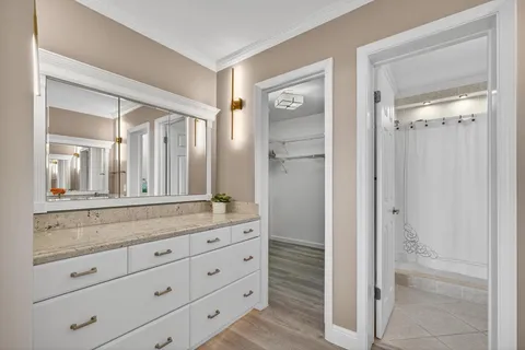 a bathroom with a granite countertop sink mirror and toilet