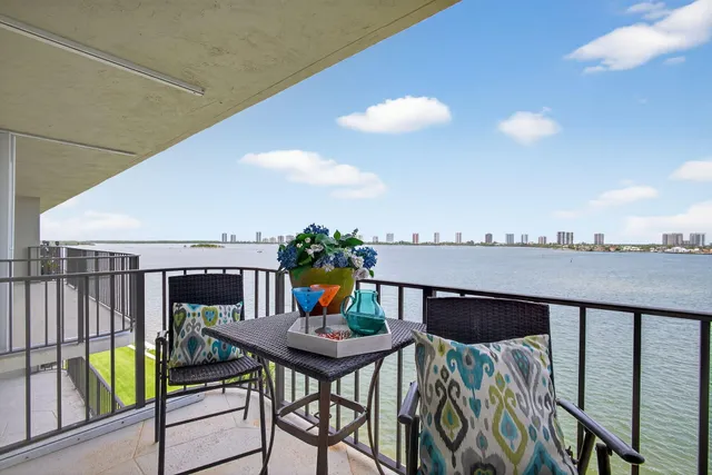 a view of a balcony dining table and chairs