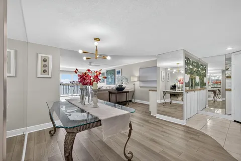 a view of a dining room with furniture and chandelier