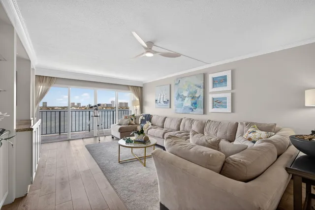 a living room with furniture and view of kitchen