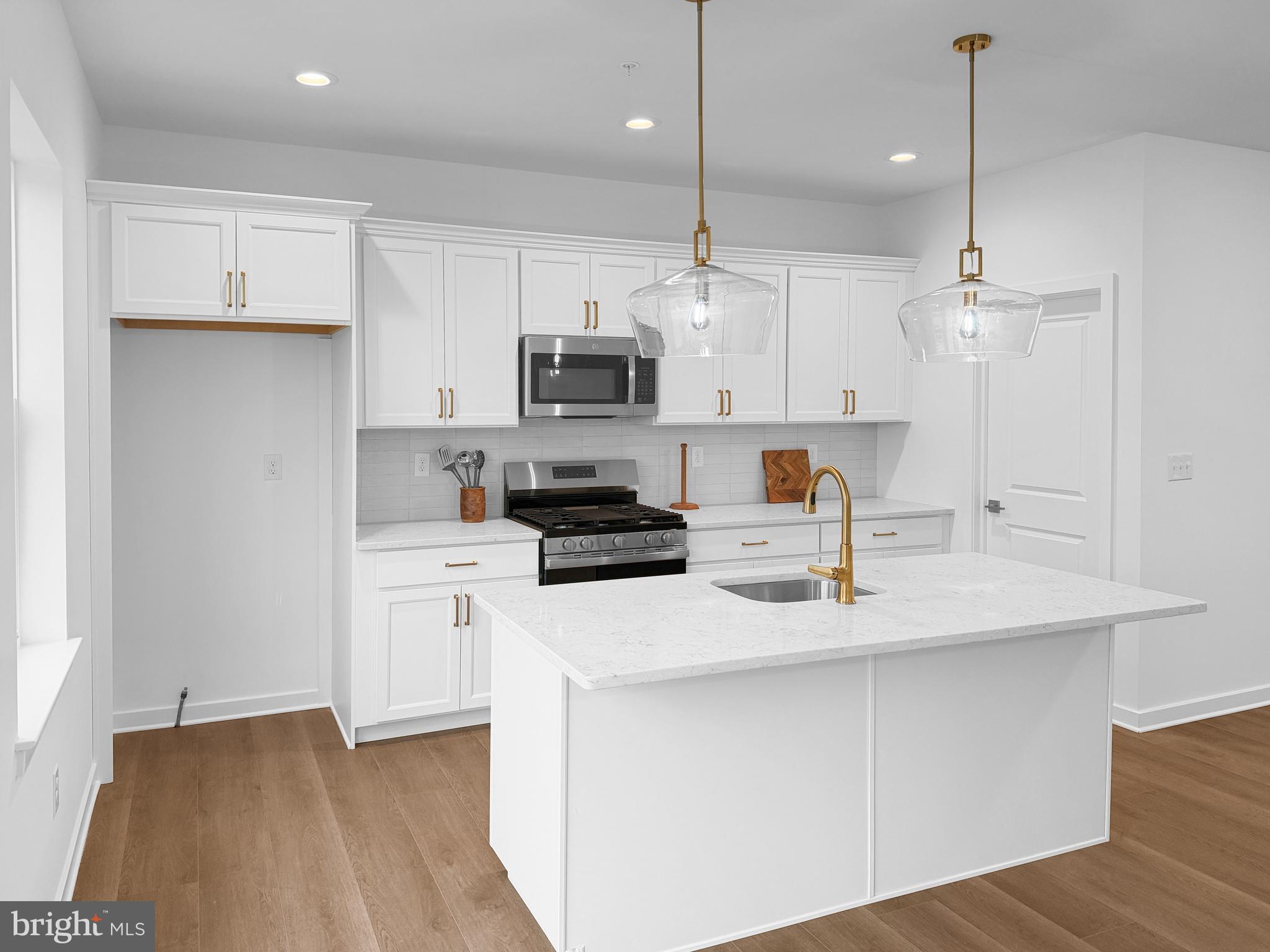 9 East Butler Avenue New Britain, PA 18901 - Photo 11 of 36 a kitchen with kitchen island a sink stainless steel appliances and white cabinets
