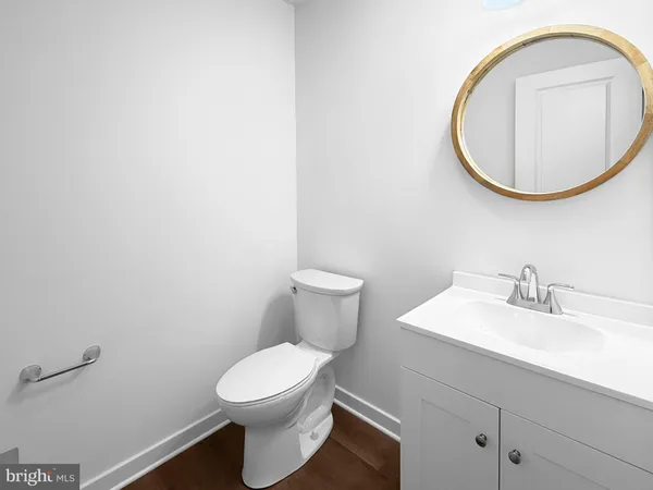 a bathroom with a sink a mirror and a toilet