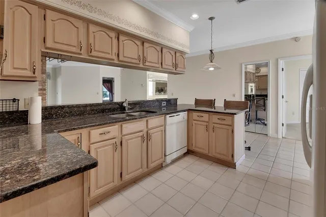a kitchen with stainless steel appliances granite countertop a sink and cabinets