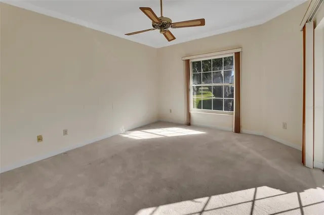 a view of a livingroom with a ceiling fan and window