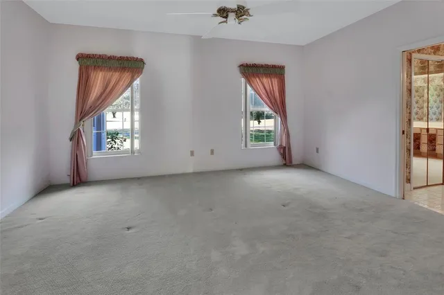 an empty room with windows and closet