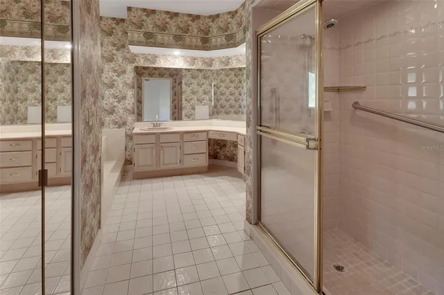 a bathroom with a tub shower and sink