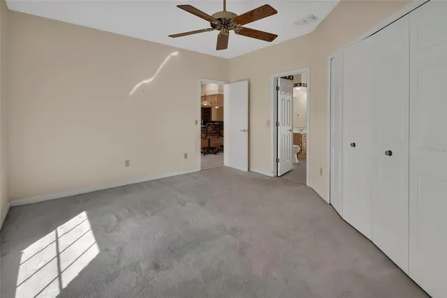 a view of a hallway with a ceiling fan
