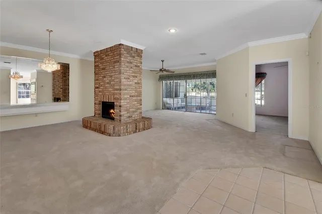 a view of an empty room with a fireplace and a window