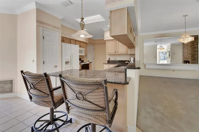 a kitchen with stainless steel appliances kitchen island granite countertop a stove a sink and a refrigerator