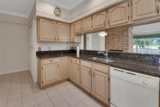 a kitchen with granite countertop white cabinets and white appliances