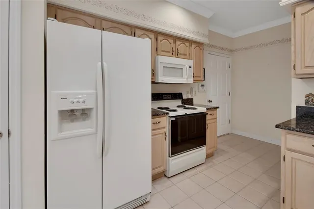 a kitchen with stainless steel appliances a refrigerator and a stove