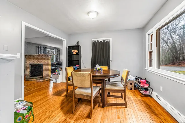 a dining room with furniture fireplace and wooden floor