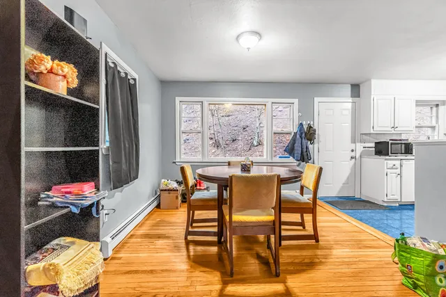 a dining room with furniture and wooden floor