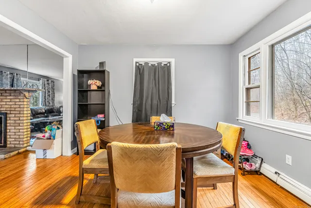 a dining room with furniture and wooden floor