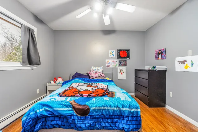 a bedroom with a bed and a dresser in it