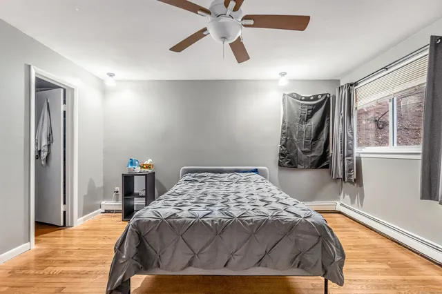 a bedroom with a bed and painting on the wall