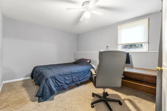 a living room with a bed furniture and a window