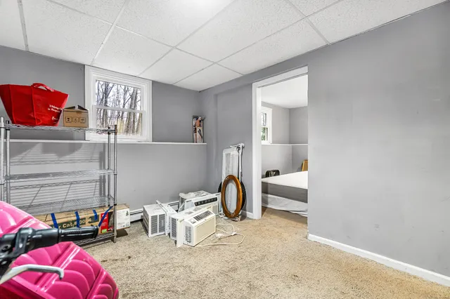 a living room with furniture and a lamp