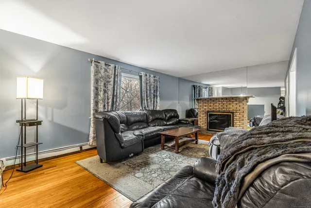 a living room with furniture fireplace and a table
