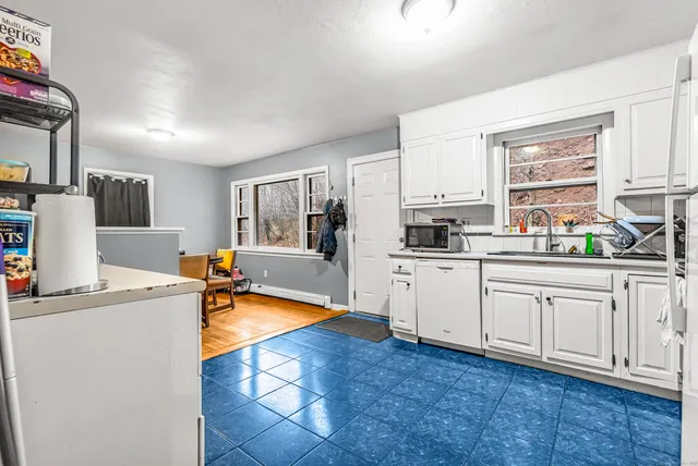 a kitchen with stainless steel appliances granite countertop a sink a stove top oven a counter space and cabinets