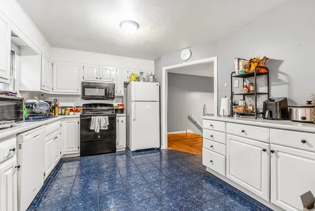 a kitchen with stainless steel appliances a refrigerator sink and cabinets