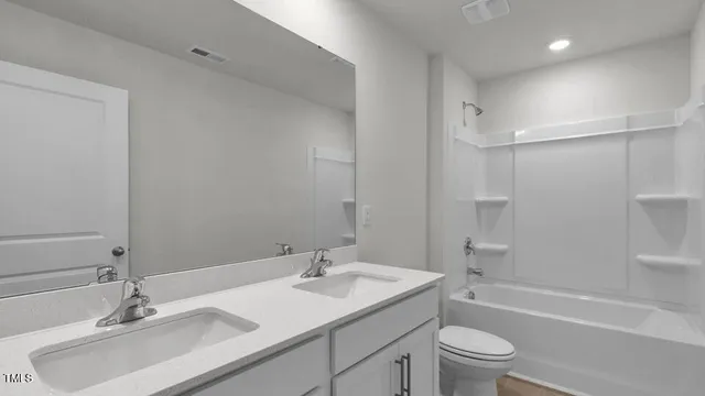 a bathroom with a sink toilet tub and shower