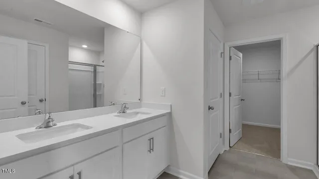 a bathroom with a double vanity sink and mirror