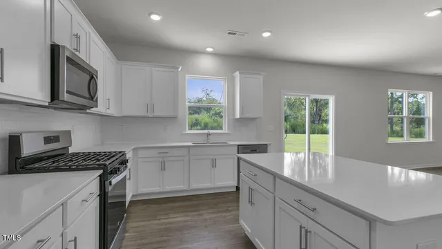 a kitchen that has a sink and a stove in it