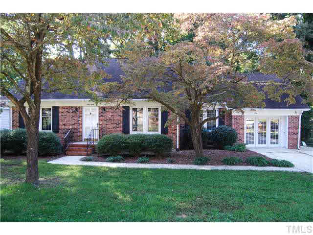 930 Pebblebrook Drive Raleigh, NC 27609 - Photo 1 of 25 a front view of a house with a yard and green space
