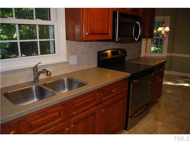 930 Pebblebrook Drive Raleigh, NC 27609 - Photo 9 of 25 a kitchen with a sink and cabinets