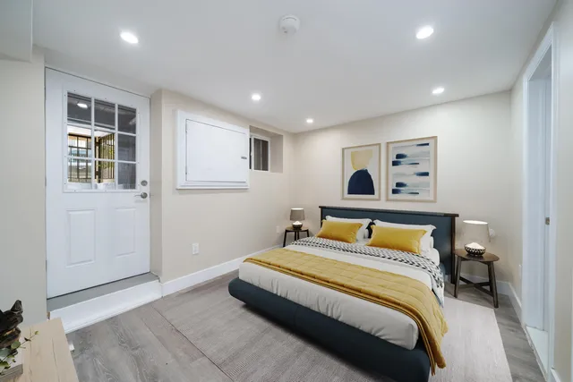 a bedroom with a bed and a painting