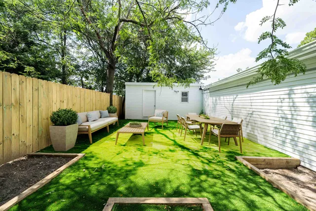 a view of an house with backyard and sitting area