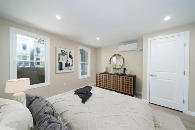 a bedroom with a bed and window