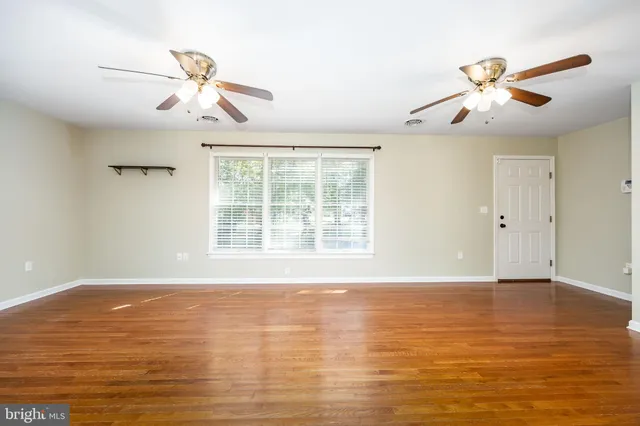 a kitchen with stainless steel appliances a stove a sink a microwave a center island and a window