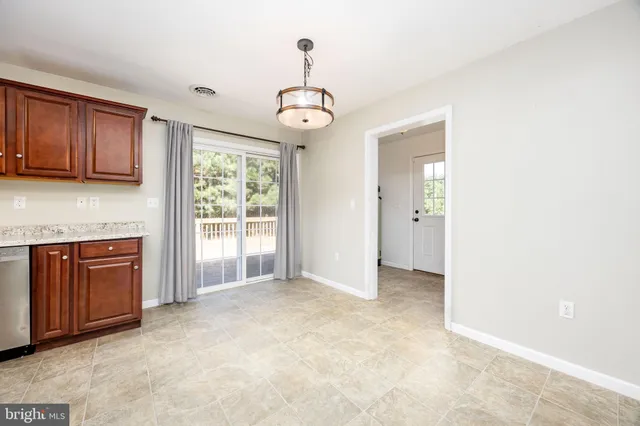a kitchen with a refrigerator stove top oven a sink and dishwasher