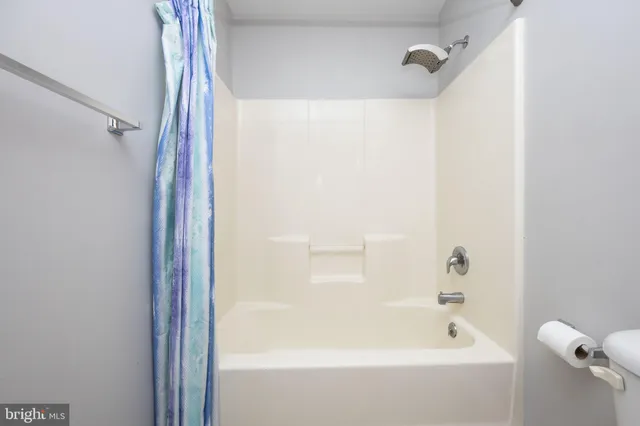 a view of a house with a yard and large trees