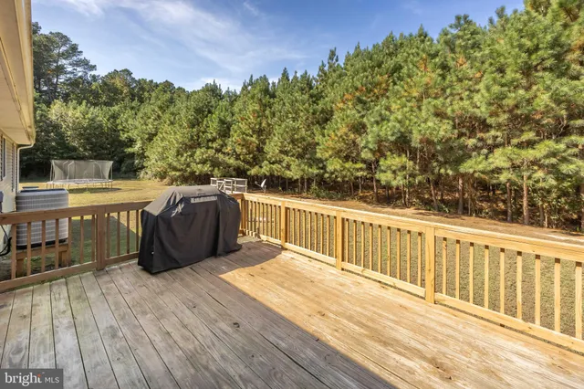 a swimming pool view with a seating space