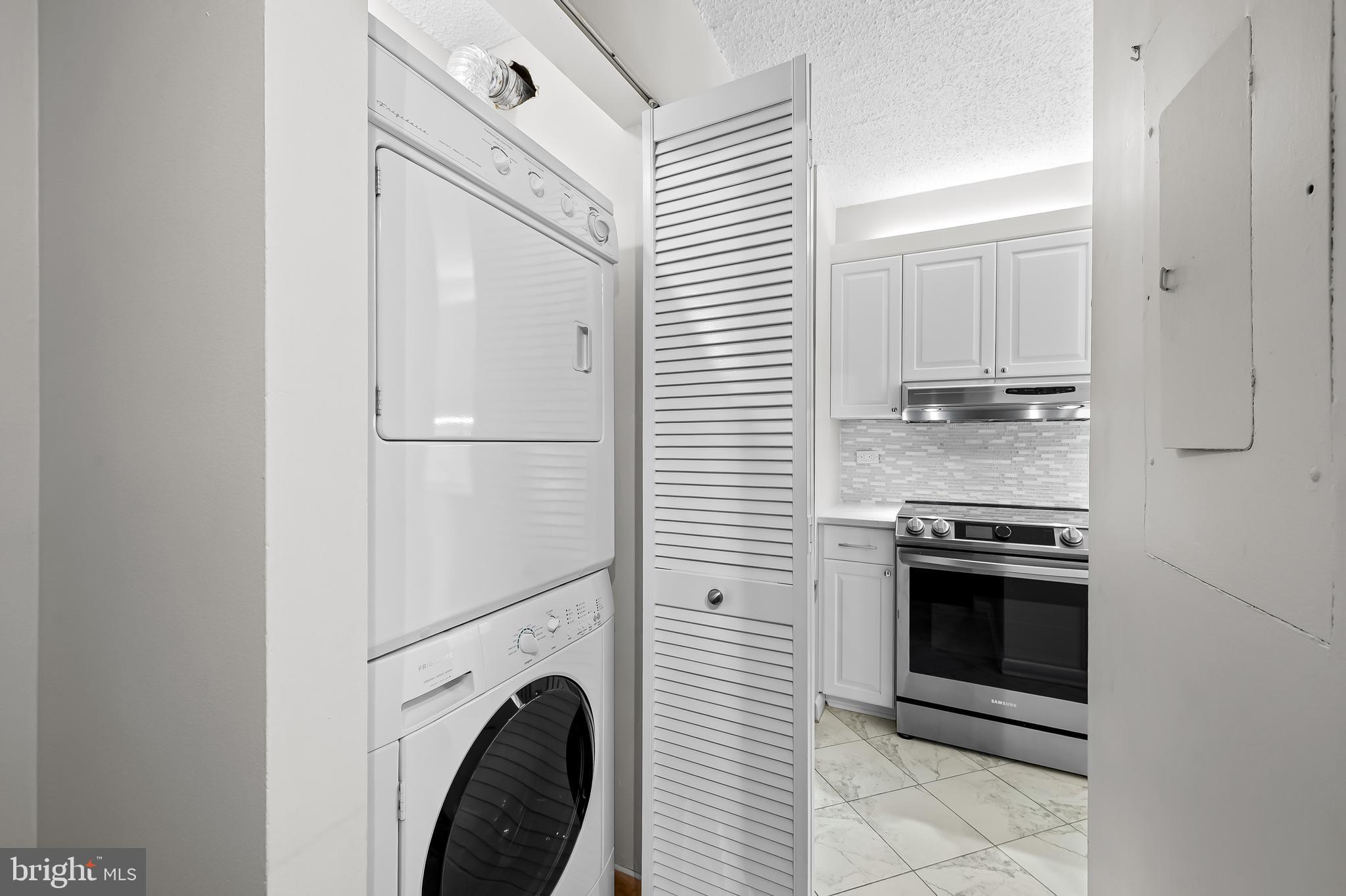 111 Hamlet Hill Road, Unit 1113 Baltimore, MD 21210 - Photo 10 of 27 a kitchen with stainless steel appliances granite countertop a stove a washer and dryer