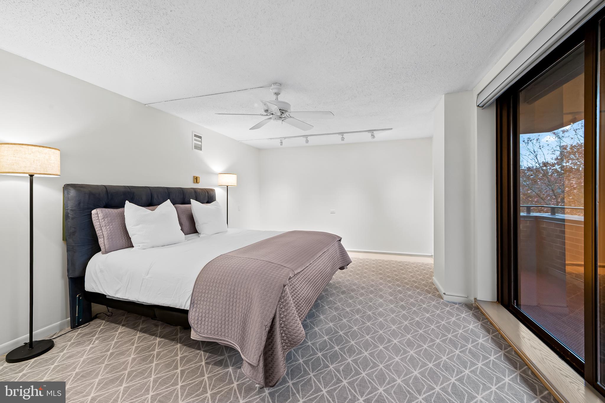 111 Hamlet Hill Road, Unit 1113 Baltimore, MD 21210 - Photo 14 of 27 a spacious bedroom with a bed and a window