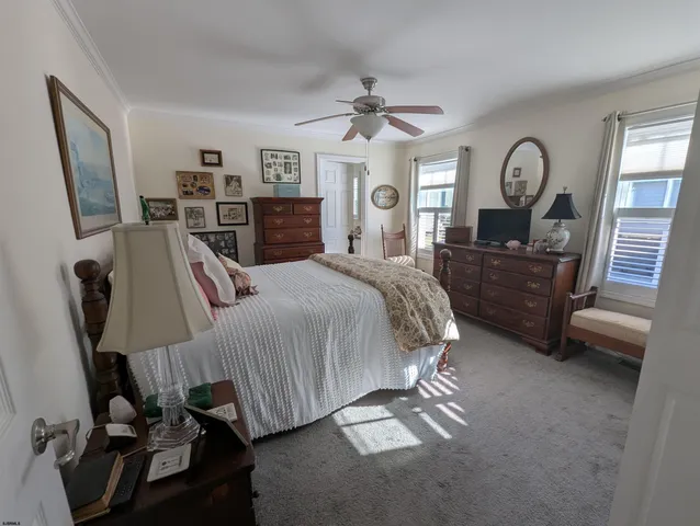 a bed room with a bed window and dresser