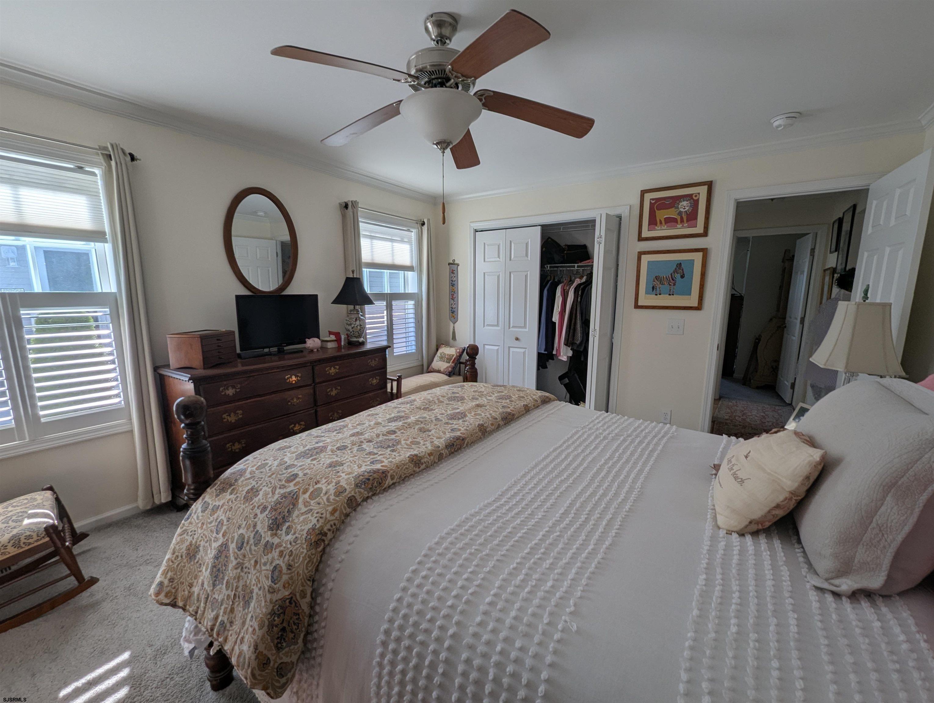 2058 Shore Road Seaville, NJ 08230 - Photo 18 of 29 a bedroom with a bed and a chandelier