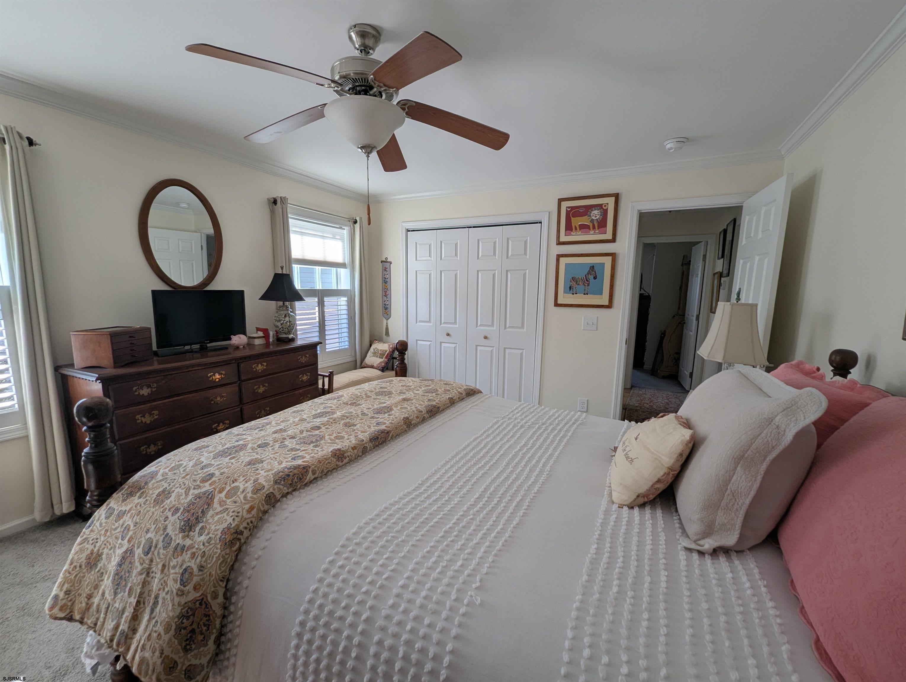 2058 Shore Road Seaville, NJ 08230 - Photo 19 of 29 a bedroom with a bed and a chandelier