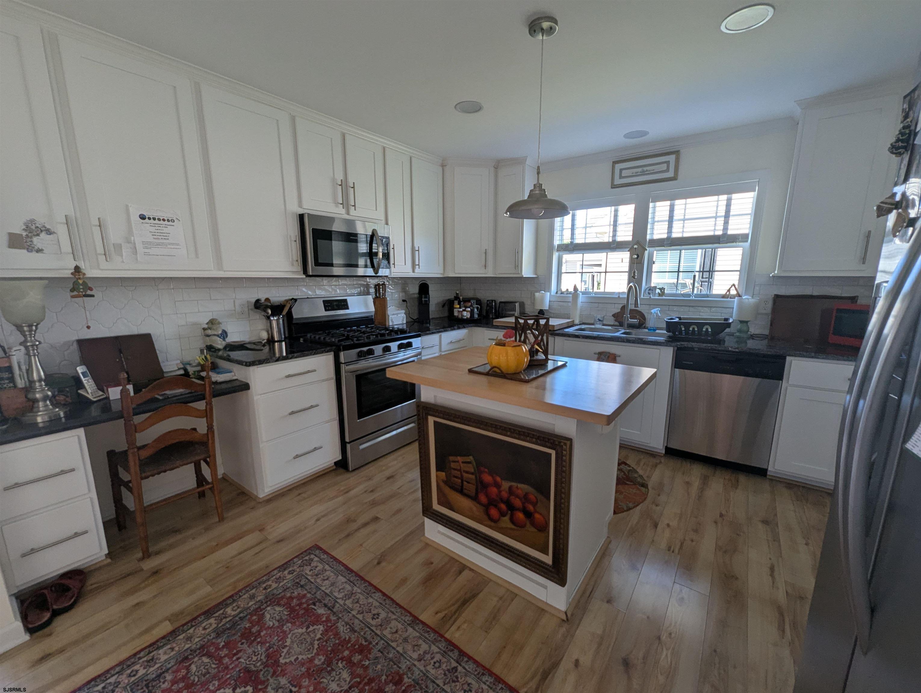 2058 Shore Road Seaville, NJ 08230 - Photo 7 of 29 a kitchen with a stove sink and cabinets