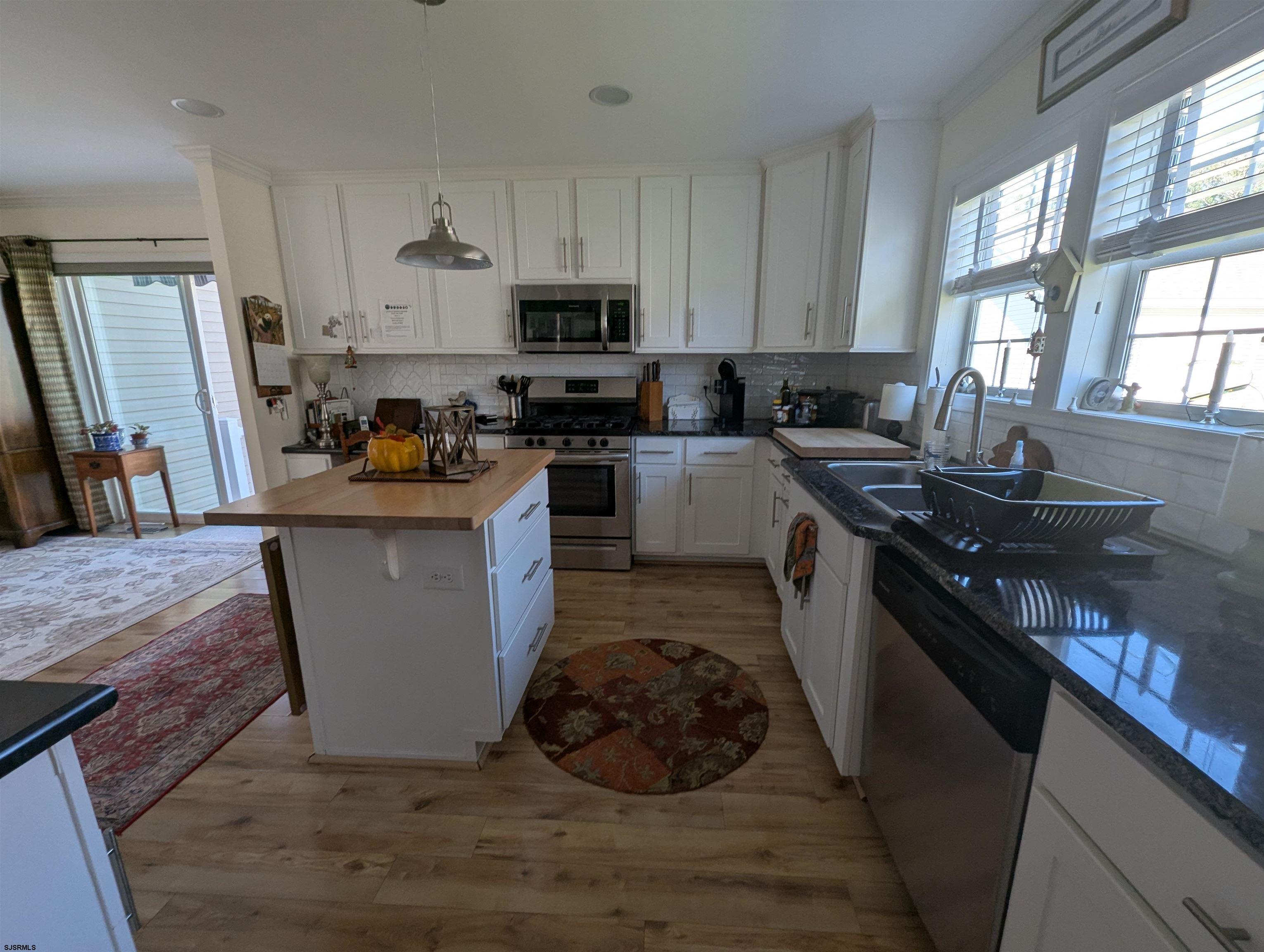 2058 Shore Road Seaville, NJ 08230 - Photo 8 of 29 a kitchen with a sink stove and cabinets