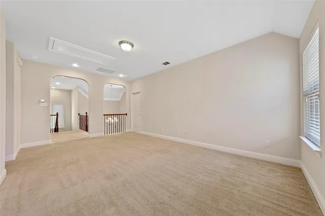 an empty room with windows and entrance