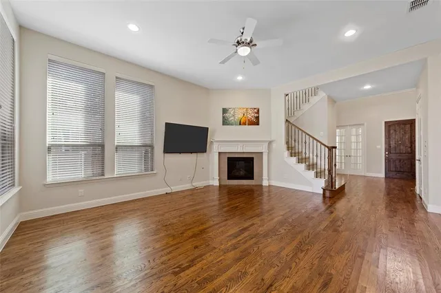 a view of a livingroom with wooden floor and fireplace