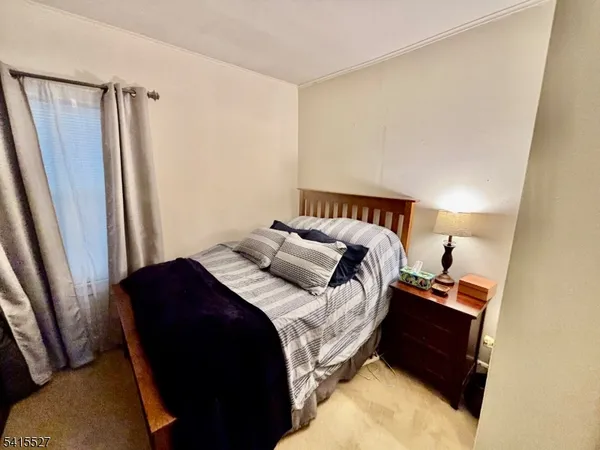 a bedroom with a bed and a mirror